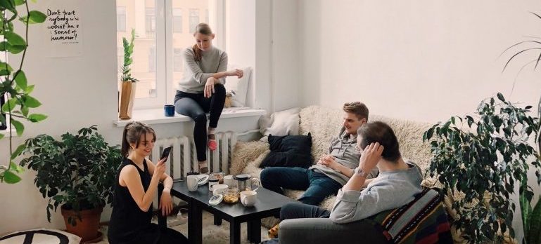 group of people sitting in an apartment