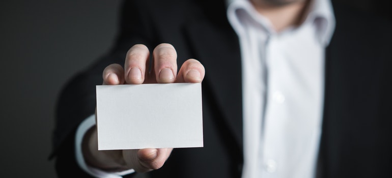 a businessman holding a card 