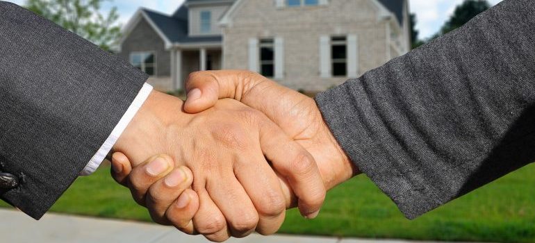 A handshake between two people after contracting Jersey City Movers