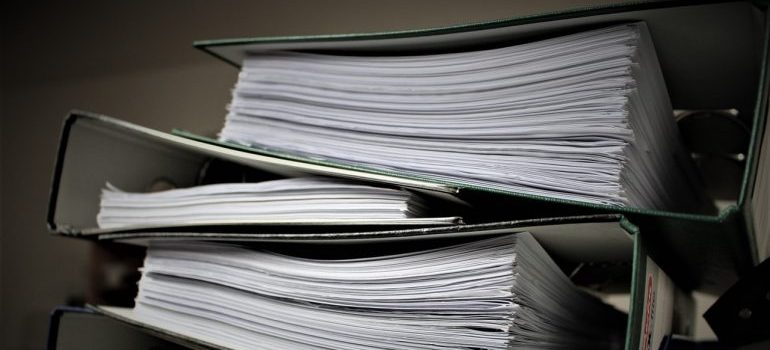 A stack of files with documents.
