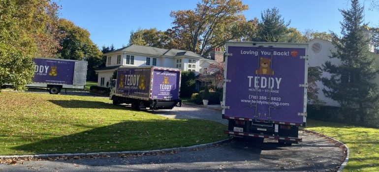 three moving trucks in the driveway