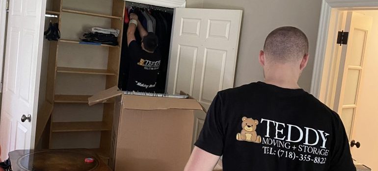 two movers emptying a closet