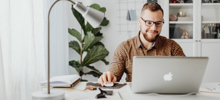 Person sitting inside of a small office and working.