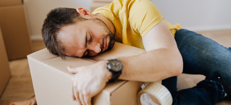 a man sleeping on a cardboard box