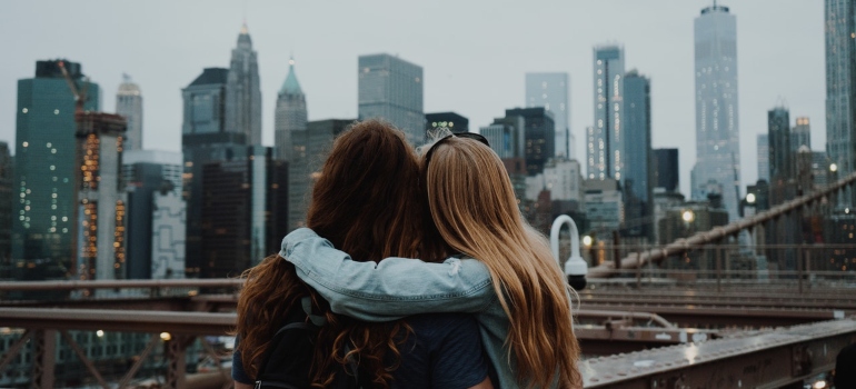 Two women hugging looking at NYC