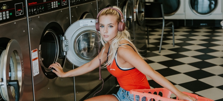 A woman in a laundromat ready to party