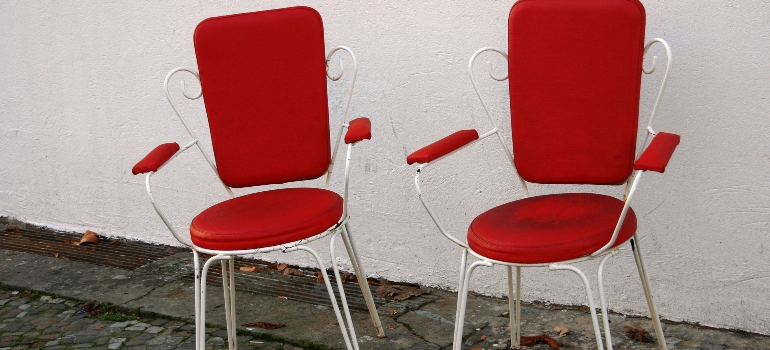 Two red seats on a street in Berlin.