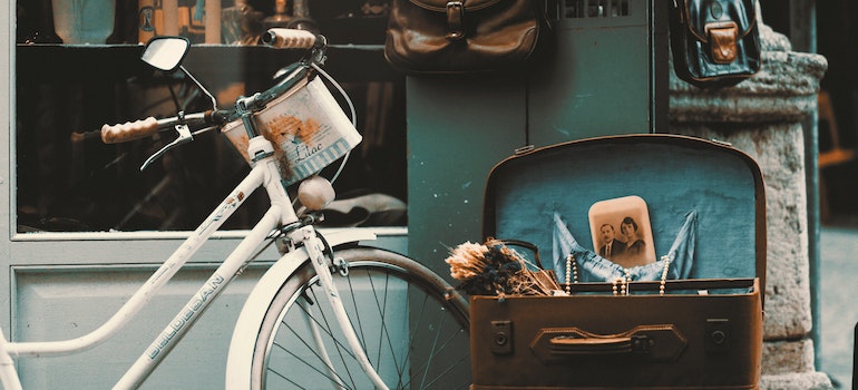 A vintage bike and an open suitcase;