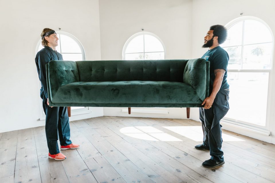 Movers carrying a luxury couch