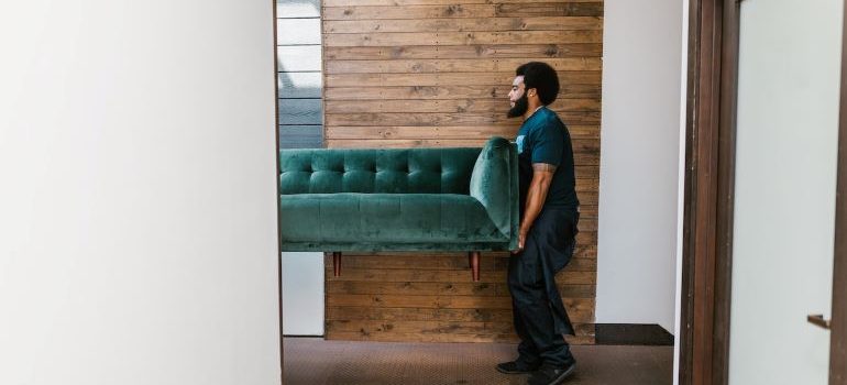 mover carrying a couch
